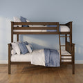 Solid wood twin-over-full bunk bed with ladder, blue and white quilted bedding and decorative pillows on hardwood floor against a light blue wall
