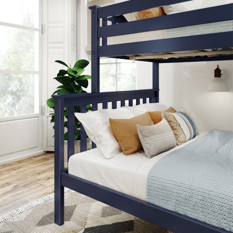 Blue bunk bed with white bedding and decorative pillows in a bright bedroom with wooden floors and a large window.