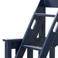 Close-up of navy blue wooden Adirondack chair showing armrest, slatted seat and oval cutout handle, painted outdoor patio furniture