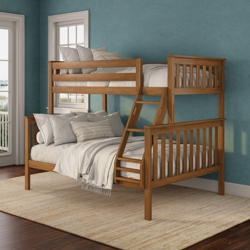 Twin-over-full solid wood bunk bed with ladder, neutral linens and striped pillow against a teal accent wall in a sunlit bedroom with large windows