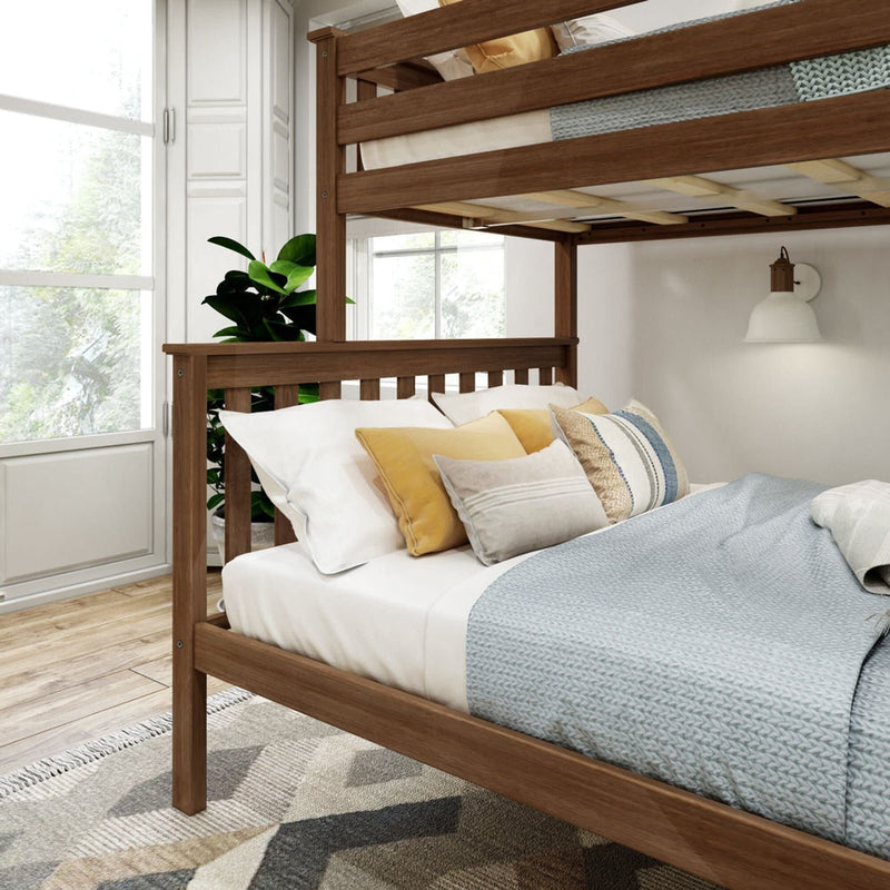 Cozy bedroom with wooden bunk beds, decorative pillows, and natural light.
