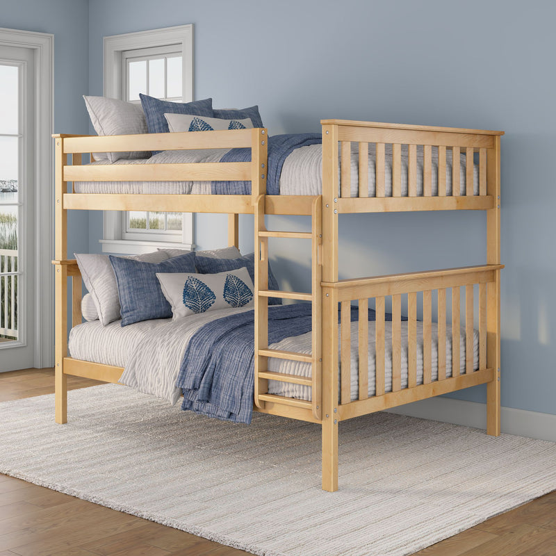 Natural light wood two-tier bunk bed with blue and gray quilts and leaf-pattern pillows in a coastal-style light-blue bedroom with windows and woven rug
