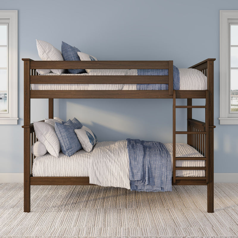 Wooden bunk bed with ladder and blue-and-white bedding against a light blue wall in a children's bedroom
