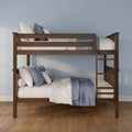 Solid wood bunk bed with blue and white quilted bedding and decorative pillows, built-in ladder on hardwood floor against a pale blue wall