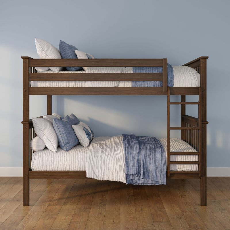 Solid wood bunk bed with blue and white quilted bedding and decorative pillows, built-in ladder on hardwood floor against a pale blue wall