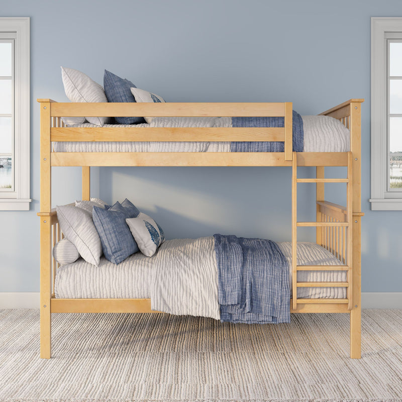 Light wood bunk bed with blue and white bedding and ladder in a bright kids' bedroom with windows