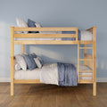 Natural wood bunk bed with ladder, layered blue and white quilted bedding and pillows in a modern children's bedroom with light blue wall and hardwood floor