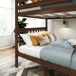 Wooden bunk bed with cozy bedding in a bright, modern bedroom featuring natural light and a decorative indoor plant.