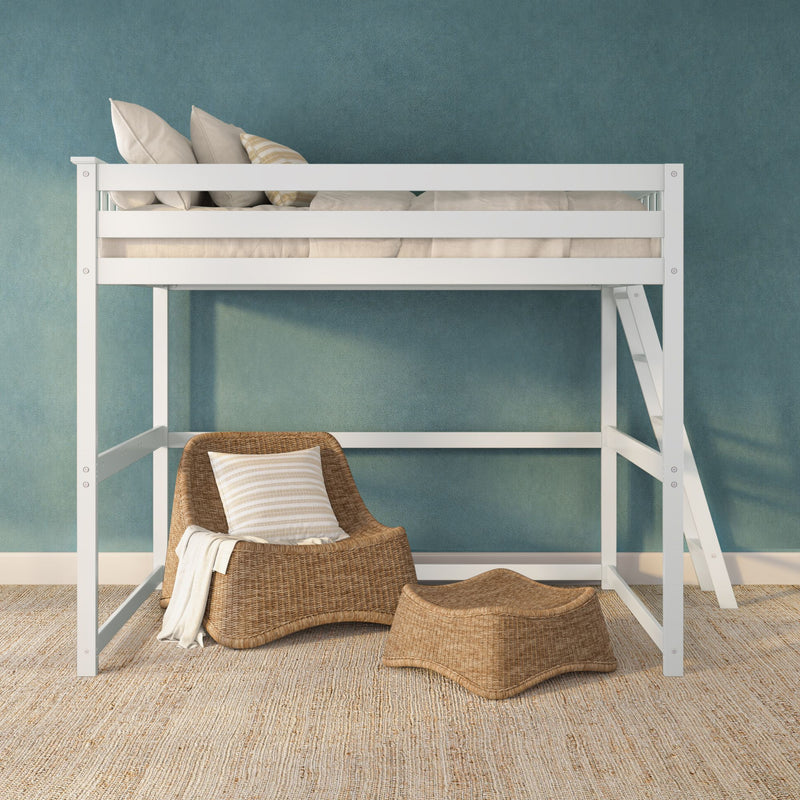White loft bed with neutral beige bedding and pillows, rattan lounge chair and ottoman on jute rug against blue textured wall — cozy modern kids' bedroom reading nook