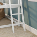 White bunk bed ladder close-up against teal textured wall with woven wicker basket, natural jute rug and white baseboard, modern coastal bedroom decor