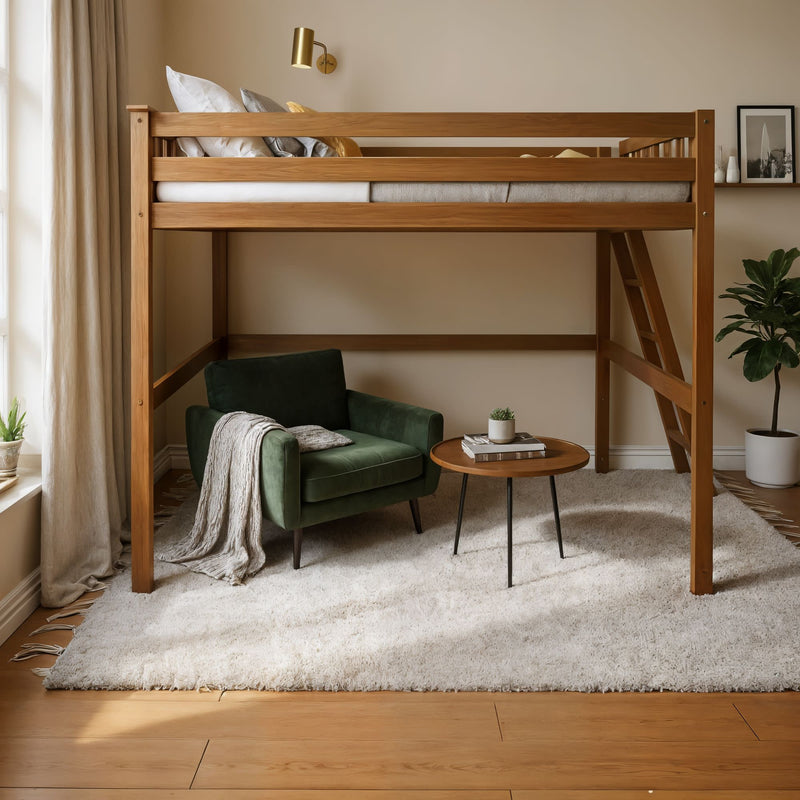 Cozy modern bedroom featuring a wooden loft bed with ladder, green velvet armchair reading nook, round wooden side table, plush white rug and potted plant by the window.