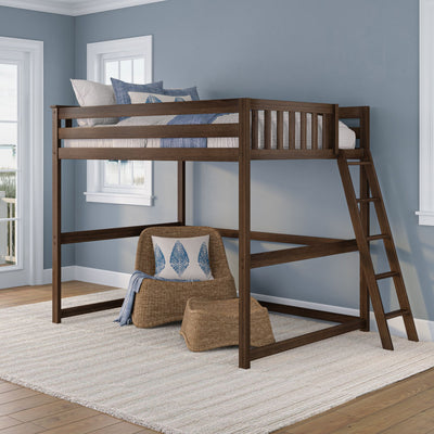 Solid dark wood loft bed with ladder, blue coastal bedding and pillows in a light blue bedroom with wicker chair and rattan ottoman