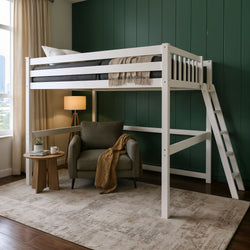 White loft bed with ladder over cozy reading nook, green accent wall, armchair, side table and floor lamp, space-saving bedroom