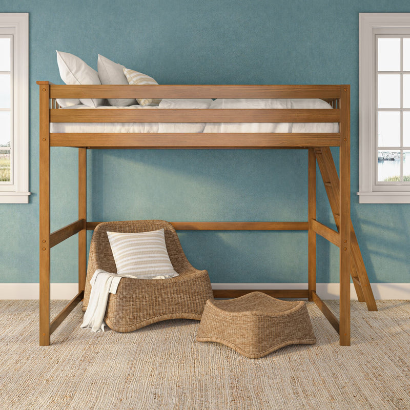 Solid wood loft bed with ladder and white bedding above a wicker lounge chair and ottoman against a coastal blue textured wall with sidelights