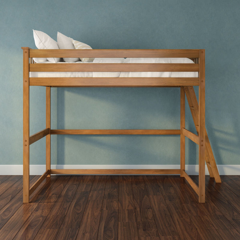 Wooden loft bed with ladder, white bedding and pillows against a blue textured wall and dark hardwood floor