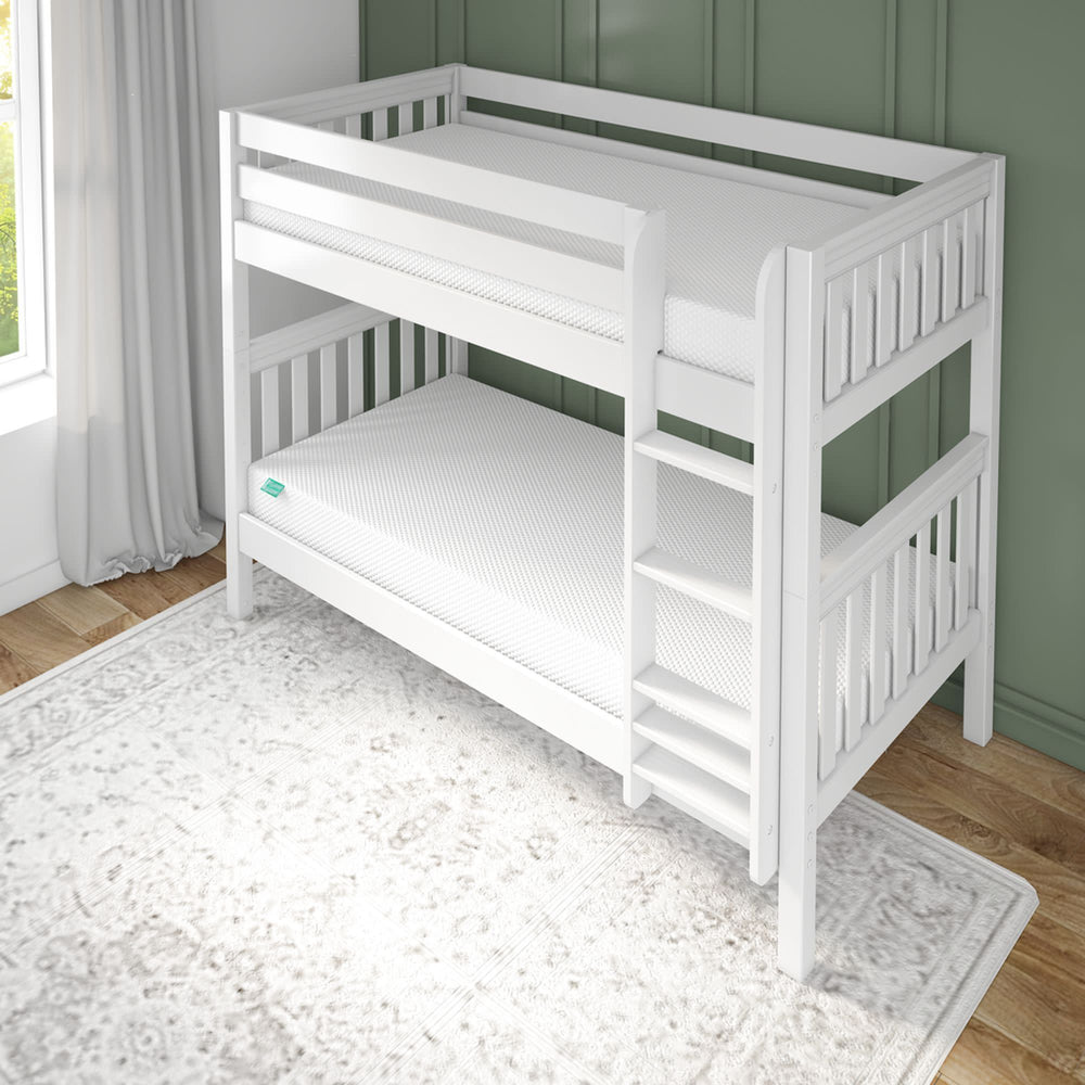 White wooden bunk bed in a bright room with a green wall and striped sheets.
