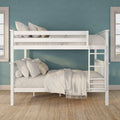 White wooden bunk bed with neutral linen bedding, striped accent pillows and ladder against a teal textured wall and windows
