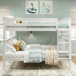 White twin-over-full wooden bunk bed with side ladder, striped teal and white bedding, mustard and gray accent pillows and beige throw in a coastal kids' bedroom with mint green walls and framed lighthouse art