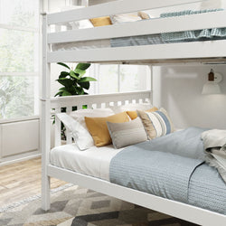 White wooden bunk bed with cozy bedding and decorative pillows in a bright bedroom.