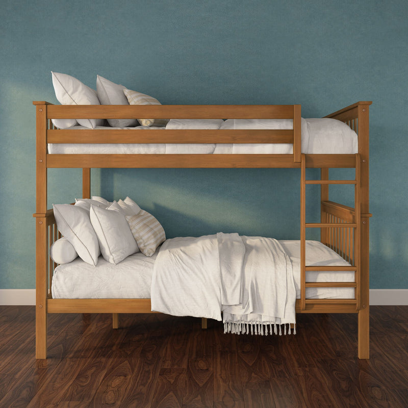 Solid wood bunk bed with white bedding and pillows against a teal textured wall on dark hardwood floor in a modern kids' bedroom