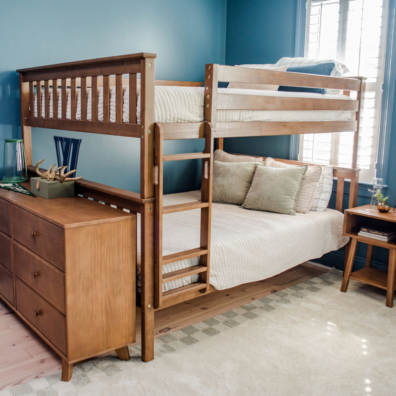 Wooden bunk bed with bedding in a blue-themed bedroom featuring a dresser and nightstand.