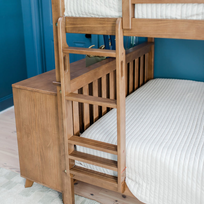 Wooden bunk bed with white quilted bedding in a modern blue bedroom setting.