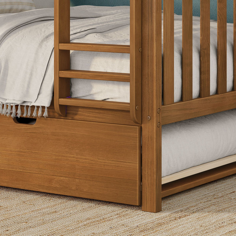 Close-up of solid wood bunk bed ladder and under-bed storage drawer with beige linen bedding and woven rug