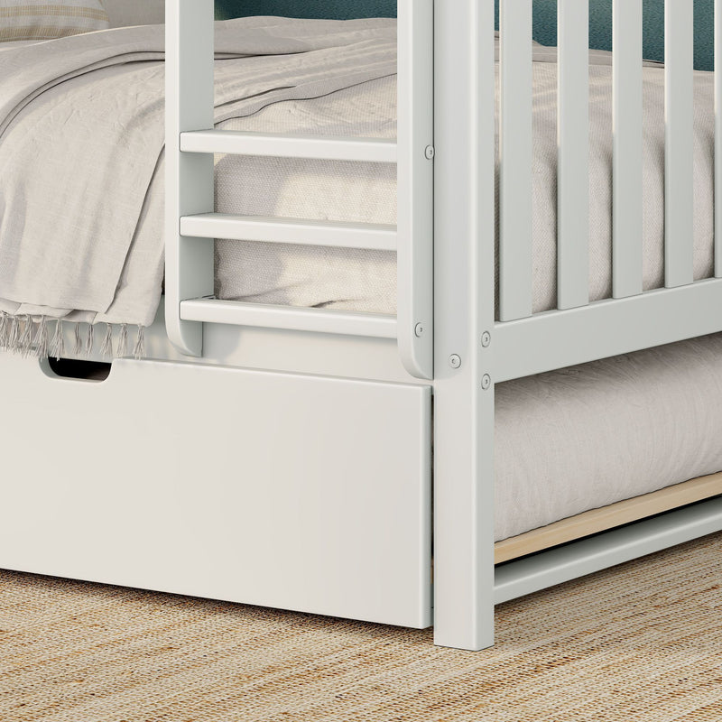 Close-up of white wooden bunk bed ladder and safety rails with beige textured bedding, tassel throw and built-in under-bed storage drawer on a natural jute rug