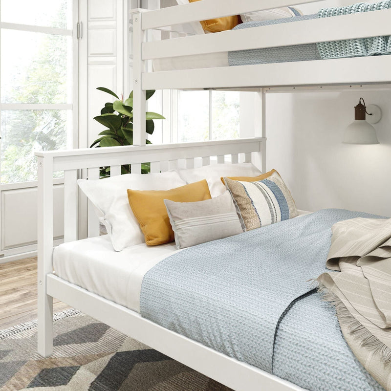 Cozy bedroom with white bunk bed, stylish pillows, and natural light.