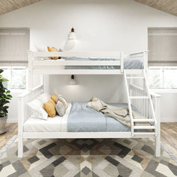 White twin over full bunk bed with cozy bedding and decorative pillows in a modern bedroom.