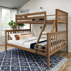 Wooden bunk bed with twin-over-full design and stylish linens in a bright, modern bedroom.