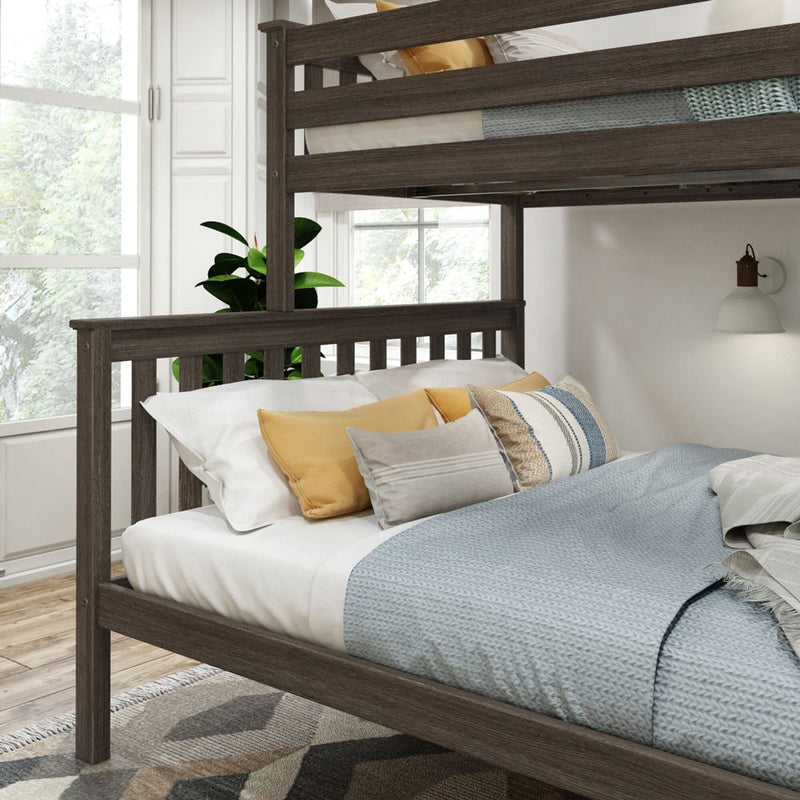 Modern wooden bunk bed with plush pillows in a sunlit bedroom.