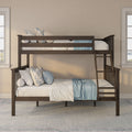 Dark wood twin-over-full bunk bed with ladder, blue-and-white floral pillows and light blue throw on neutral bedding in a bright kids' bedroom with tall windows