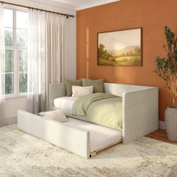 Cozy small bedroom with pull-out trundle bed, sage green bedding, terracotta accent wall, sheer curtains and framed landscape art