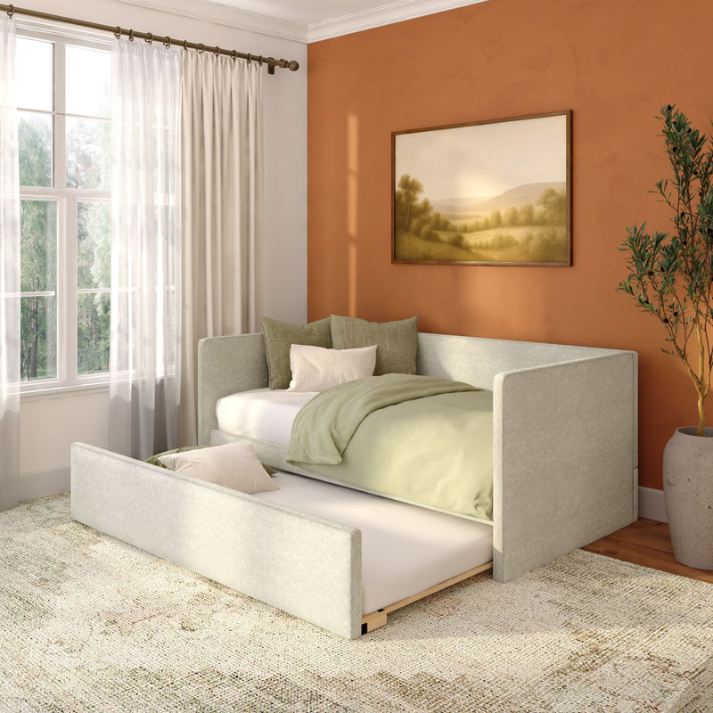 Cozy small bedroom with pull-out trundle bed, sage green bedding, terracotta accent wall, sheer curtains and framed landscape art