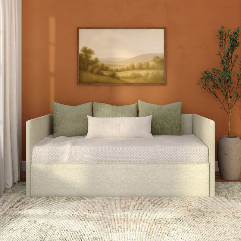 Cozy modern living room interior with sage green sofa-daybed and pillows, rust orange accent wall, framed landscape painting, potted olive tree and neutral textured area rug