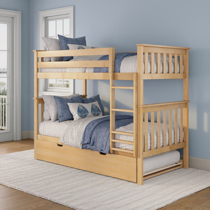 Natural wood bunk bed with ladder and pull-out trundle, blue and gray bedding and leaf-pattern pillows in a coastal kids' bedroom
