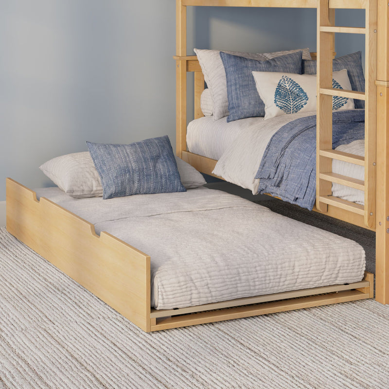 Light wood bunk bed with pull-out trundle, neutral quilted bedding and blue decorative pillows in a cozy modern bedroom.