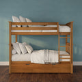 Solid wooden bunk bed with ladder and under-bed storage drawers, white linens and pillows against a teal textured wall on hardwood floor