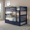 Space-saving navy blue wooden bunk bed with pull-out trundle and ladder, styled with blue and cream bedding in a sunlit bedroom near windows