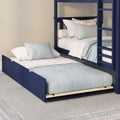 Solid navy blue twin-over-twin bunk bed with pull-out trundle, ladder and light blue linens in a modern kids' bedroom