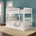 White wooden bunk bed with pull-out trundle, neutral linen bedding and ladder against teal textured wall in coastal kids bedroom
