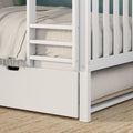 Close-up of modern white wooden bunk bed ladder and safety guardrail with light gray bedding, tassel throw, storage drawer cutout and woven jute rug