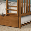 Solid wood bunk bed corner with built-in ladder and under-bed storage drawer, natural oak finish, neutral textured bedding and woven rug