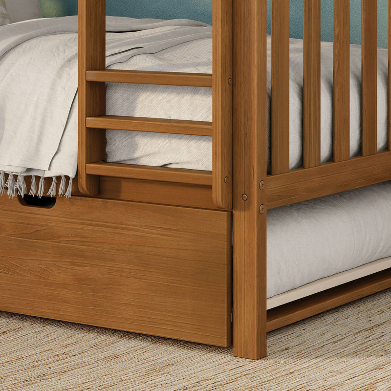 Solid wood bunk bed corner with built-in ladder and under-bed storage drawer, natural oak finish, neutral textured bedding and woven rug