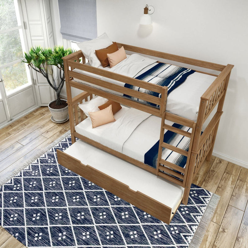 Wooden bunk bed with a pull-out trundle in a modern bedroom featuring a blue geometric rug and natural light from large windows.