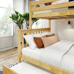 Wooden bunk bed with white bedding and decorative pillows in a bright room with large windows and green indoor plants.