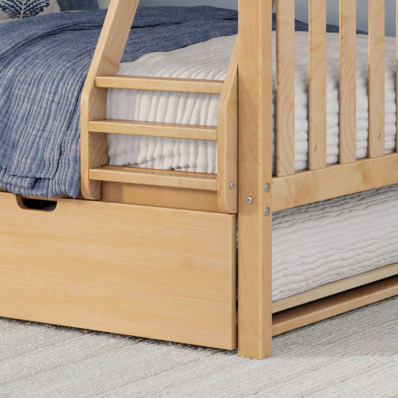 Close-up of light wood bunk bed ladder and slatted guardrail with blue quilted bedding, white mattress and under-bed storage drawer on a textured rug