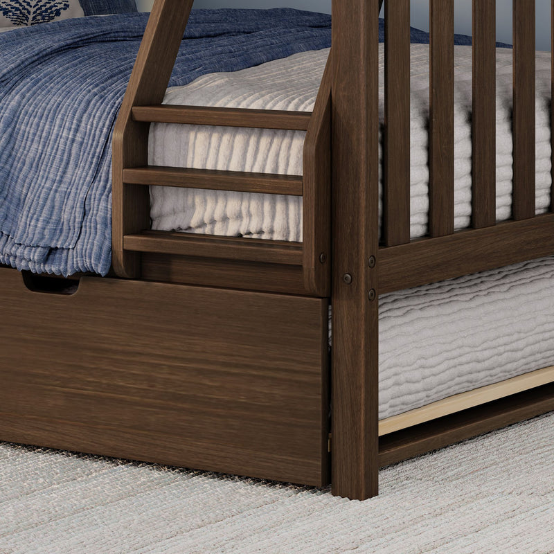 Walnut wooden bunk bed close-up showing ladder, guardrail, blue quilt, gray blanket and underbed storage drawer