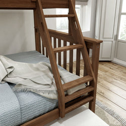 Wooden bunk bed with ladder in a modern bedroom featuring a cozy blanket and hardwood flooring.
